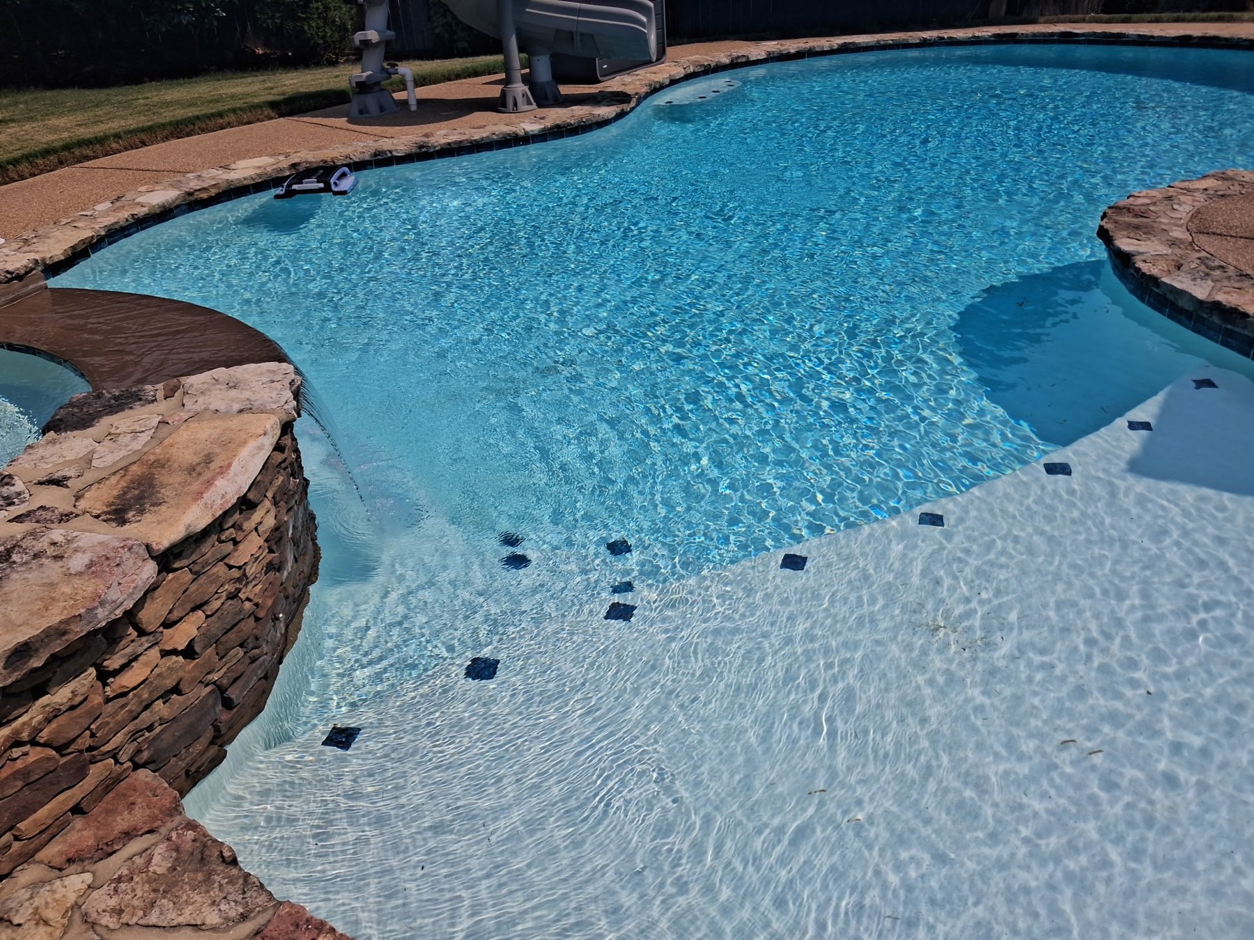 Clean residential swimming pool serviced by Clear Water Pool Services